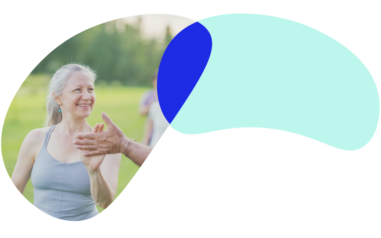 Adults high-fiving during an outdoor exercise